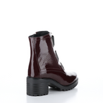 Load image into Gallery viewer, Outer back side view of the Bos &amp; Co patent leather boot in the color bordeaux/bordo. This boot has a chunky mid-heel and 3 elastic bands on the front.

