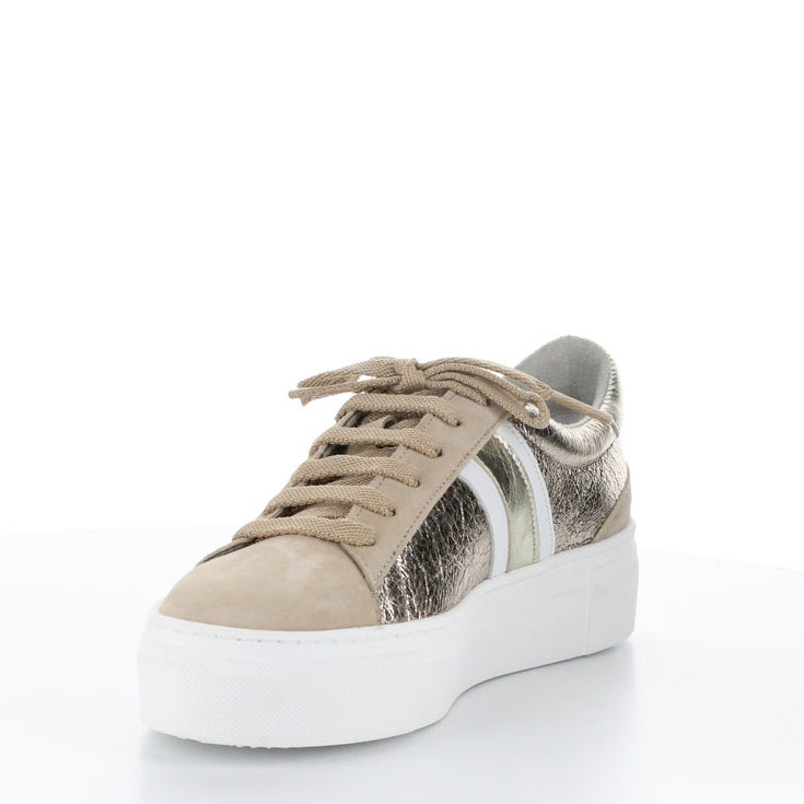 Front inner side of the bos & co monic sneaker. This sneaker is beige with crinkled metallic sides, white and silver side stripes, a lace up front, and a platform sole.