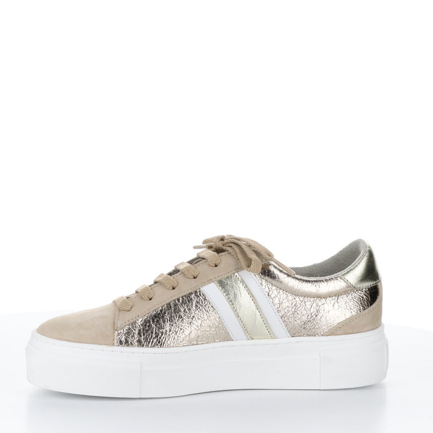 Inner side of the bos & co monic sneaker. This sneaker is beige with crinkled metallic sides, white and silver side stripes, a lace up front, and a platform sole.