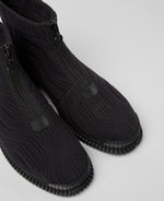Load image into Gallery viewer, close up birdseye view of a pair of the camper pix tencel boots. These boots are black with a textile fabric upper that have a curved pattern. The boots have a rubber sole and a zipper in the front.
