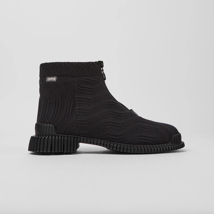 Outer side view of the camper pix tencel boots. These boots are black with a textile fabric upper that have a curved pattern. The boots have a rubber sole and a zipper in the front.