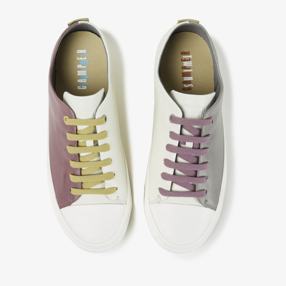 Birdseye view of a pair of the camper twins sneaker. The left sneaker is white on one side and grey on the other with purple laces. The right foot is white on one side and purple on the other side with mustard laces.