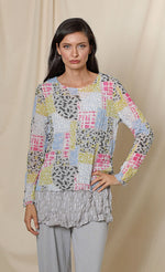 Load image into Gallery viewer, Front top half view of the chalet andrea basic top. This top has long sleeves, a round neck, crinkled fabric, and a multicolored patchwork print.
