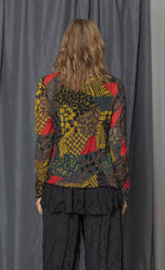 Load image into Gallery viewer, Back top half view of a woman wearing the chalet andrea patch top. This top has long sleeves, a round neck, and a relaxed fit. The top has a mix of yellow, brown, and red print.
