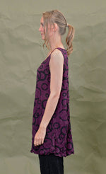 Load image into Gallery viewer, left side top half view of a woman wearing the chalet liz tank in acai. This tank is purple colored with a black circles.
