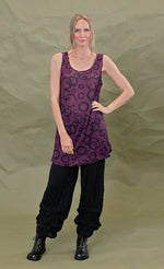 Load image into Gallery viewer, Front full body view of a woman wearing the chalet liz tank in acai. This tank is purple colored with a black circles.
