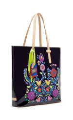 Load image into Gallery viewer, Front view of the consuela tia slim tote. This tote is a glossy black with a thin tan leather strap and colorful embroidery on the front.
