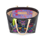 Load image into Gallery viewer, Inner view of the consuela tia slim tote. This tote is a glossy black with a thin tan leather strap and colorful embroidery on the front. The inside has a slide pocket.
