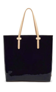Back view of the consuela tia slim tote. This tote is a glossy black with a thin tan leather strap.