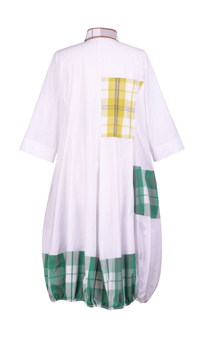 Back view of the alembika plaid wonderful dress. This dress is white with yellow, green, and brown plaid panelling/patches. The dress has short sleeves. The bottom is wide and full.