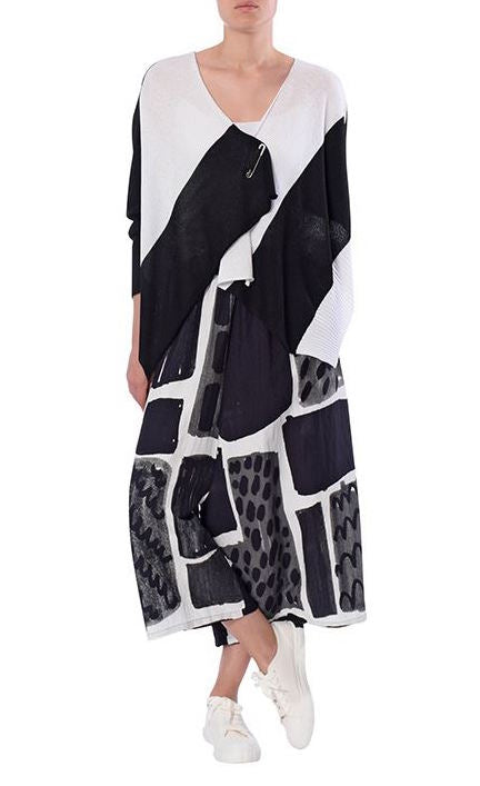 Front full body view of a woman wearing a black and white top with the crea concept black and white print pant. This pant has an abstract print on it and a wide leg.