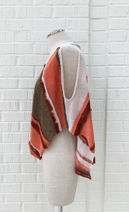 Left side view of the crea concept asymmetrical knit top. The left side of this top is army and salmon striped with a sleeveless and draped look. 