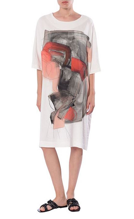 Front full body view of a woman wearing the Crea Concept Abstract T-Shirt Dress. This dress is white with 3/4 length sleeves, a round neck, and an abstract grey/orange print in the front.
