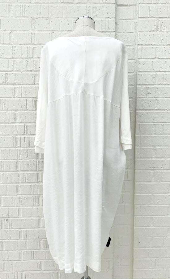 Back view of the Crea Concept Abstract T-Shirt Dress. This dress is solid white on the back and has 3/4 length sleeves.