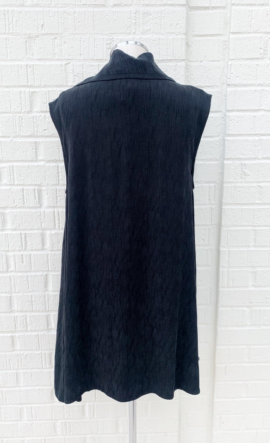 Back view of the crea concept black vest/top. This top is sleeveless with long solid back.