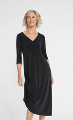 Load image into Gallery viewer, Front angle of woman wearing a black mid-length drama dress with 3/4 sleeves from Sympli

