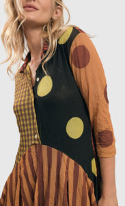 Front top half view of a woman wearing the alembika mix pocket dress.