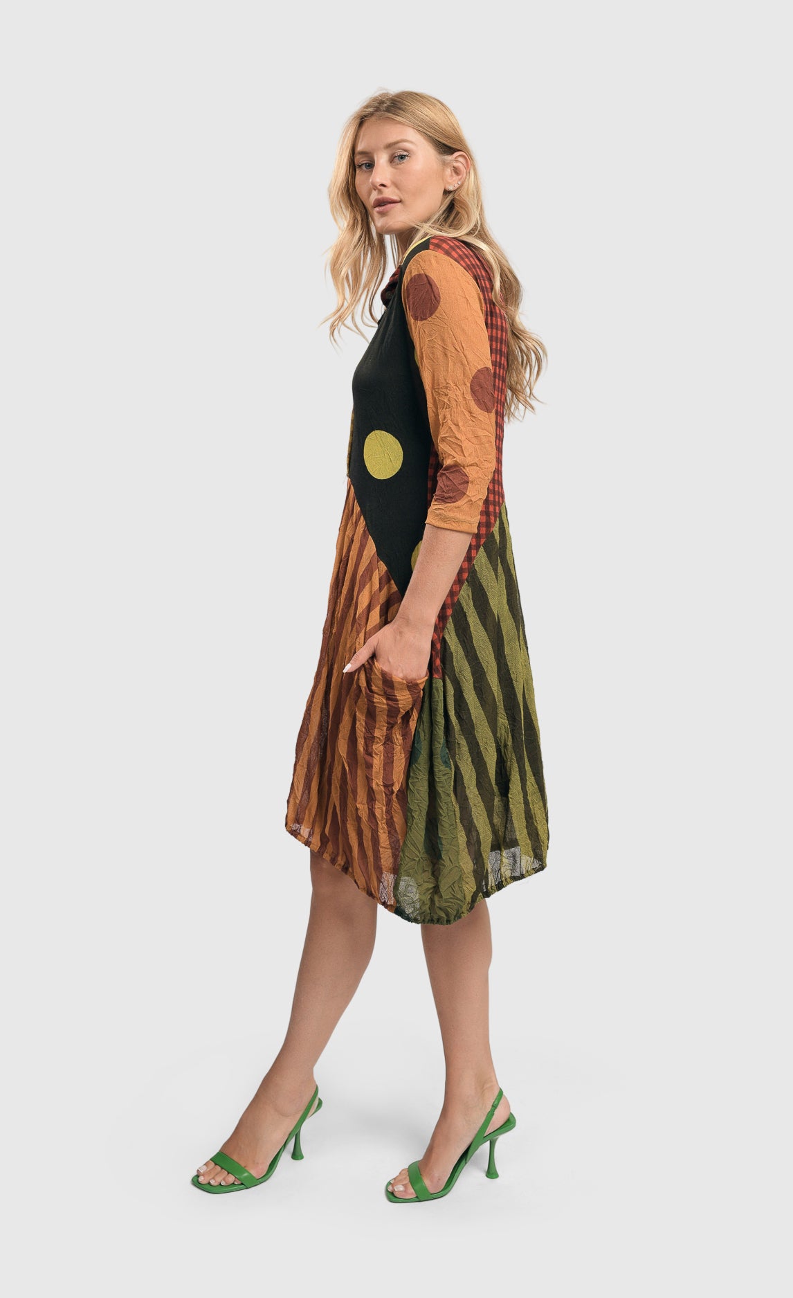 Left side full body view of a woman wearing the alembika mix pocket dress.