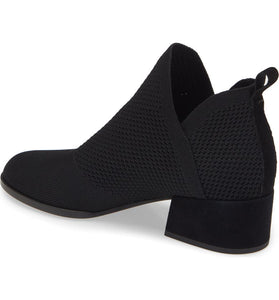 Inner side view of the eileen fisher clever knit bootie. This bootie us black with a knitted fabric upper, side slits, and a block heel.