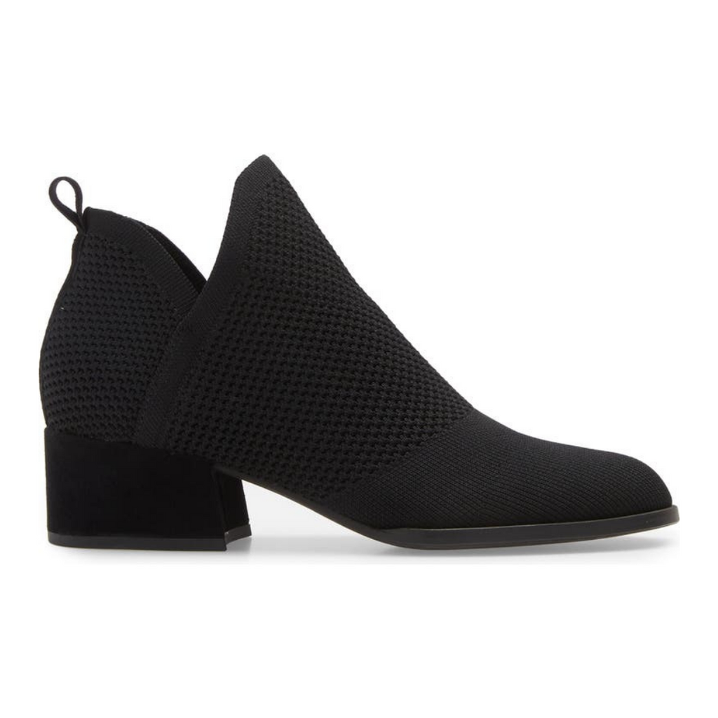 Outer side view of the eileen fisher clever knit bootie. This bootie is black with a knitted fabric upper, side slits, and a block heel.