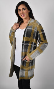 Front top half view of a woman wearing the frank lyman plaid sweater jacket. This jacket is open over a white tank and the model is wearing it with black sweatpants. The grey and mustard jacket has long sleeves and two front patch pockets.