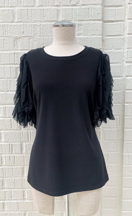Front view of a mannequin wearing a black jersey knit top with sheer sleeves from Frank Lyman. The sheer sleeves are ruffled and 3/4 length.