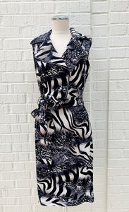 Front view of a mannequin wearing the Frank Lyman Wild Thing Dress. This dress features a navy, beige, and white animal print and zebra print mixed fabric, a tie belt at the waist, and a flat, notched collar with an off-center zipper.