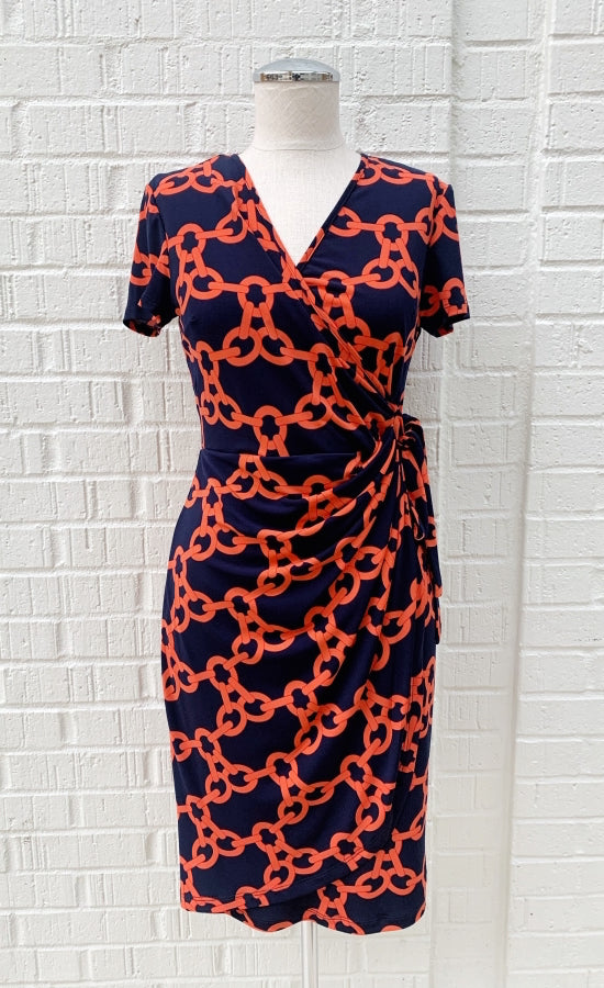 Front view of navy and orange short sleeve chain print wrap dress from Frank Lyman on a mannequin