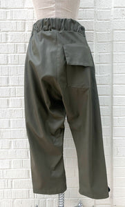 Back bottom half view of the hashtagmart green crop pant. This pant has an elastic waistband, a wide leg, a single back pocket on the right side, and a drop crotch. The fabric looks like leather.