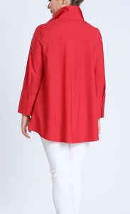 Back top half view of a woman wearing white pants and the IC collection Red Shirt. This shirt has a shirt collar, long sleeves, and a flowy silhouette..