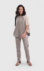 Load image into Gallery viewer, Front full body view of a woman wearing a grey alembika top and the alembika grey iconic stretch jeans. These light grey jeans have a relaxed slim/straight cut.
