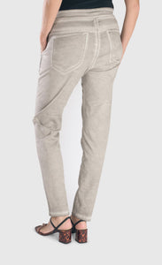 Back bottom half view of a woman wearing the alembika grey iconic stretch jeans. These light grey jeans have a wide waistband, two back pockets and a relaxed slim/straight cut.