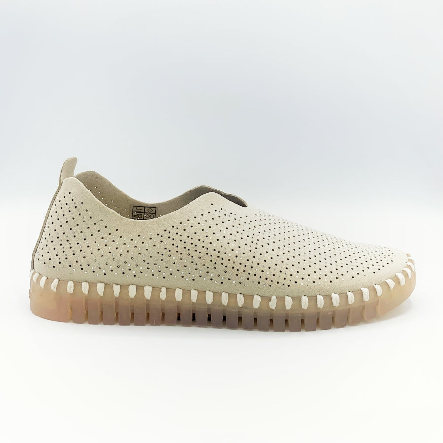 Outer side view of the Ilse Jacobsen flat shoe in creme. This shoe has a gummy sole. The upper features perforated holes and sparkles