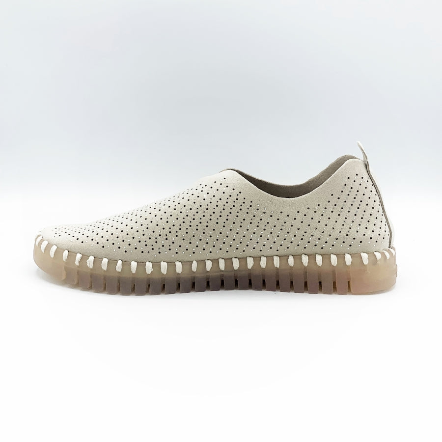 Inner side view of the Ilse Jacobsen flat shoe in creme. This shoe has a gummy sole. The upper features perforated holes and sparkles