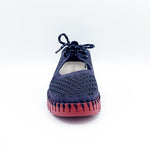 Load image into Gallery viewer, Front view of the ilse jacobsen tie flat. This flat is navy with a red sole. The upper has a scale like pattern with perforated tiny holes all over it. The shoe has a lace up front.
