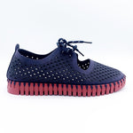 Load image into Gallery viewer, Outer side view of the ilse jacobsen tie flat. This flat is navy with a red sole. The upper has a scale like pattern with perforated tiny holes all over it. The shoe has a lace up front.
