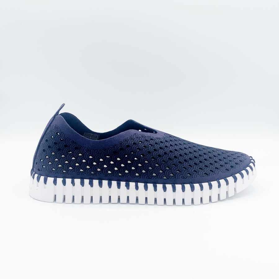 Outer view of the ilse jacobsen tulip flat in navy. This flat shoe has a white sole and a scale-like navy upper. The upper is perforated with tiny holes all over it.
