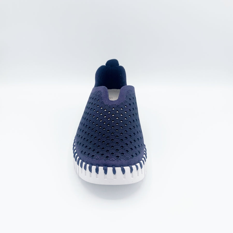 Front view of the ilse jacobsen tulip flat in navy. This flat shoe has a white sole and a scale-like navy upper. The upper is perforated with tiny holes all over it.