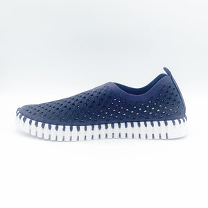 Inner view of the ilse jacobsen tulip flat in navy. This flat shoe has a white sole and a scale-like navy upper. The upper is perforated with tiny holes all over it.
