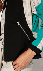 Load image into Gallery viewer, Close up view of the indies nano jacket&#39;s front zipper pocket. The front panel is black.
