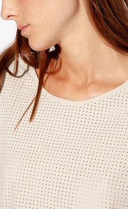 Front close up view of the neckline of the Indies Cara Tee-Shirt. This shirt has perforated fabric and is pebble/beige colored 