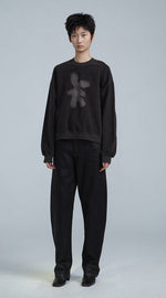Load image into Gallery viewer, Front full body view of a woman wearing the jnby rabbit sweater. This sweatshirt is smoke/black colored with a light grey rabbit on the front.

