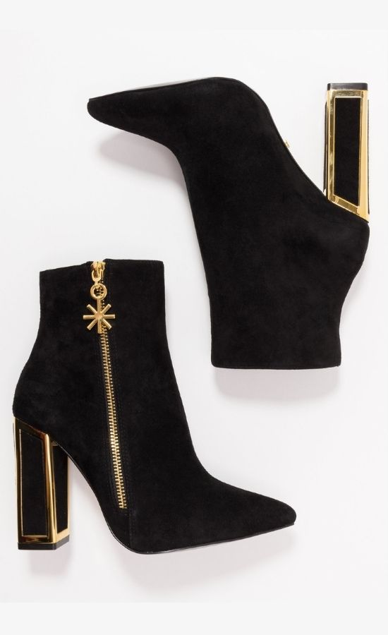 Outer and inner side view of a pair of the black kat maconie anges boots. These boots have a high heel and the heel is framed with gold. The outer side has a gold zipper with a star pull tab.