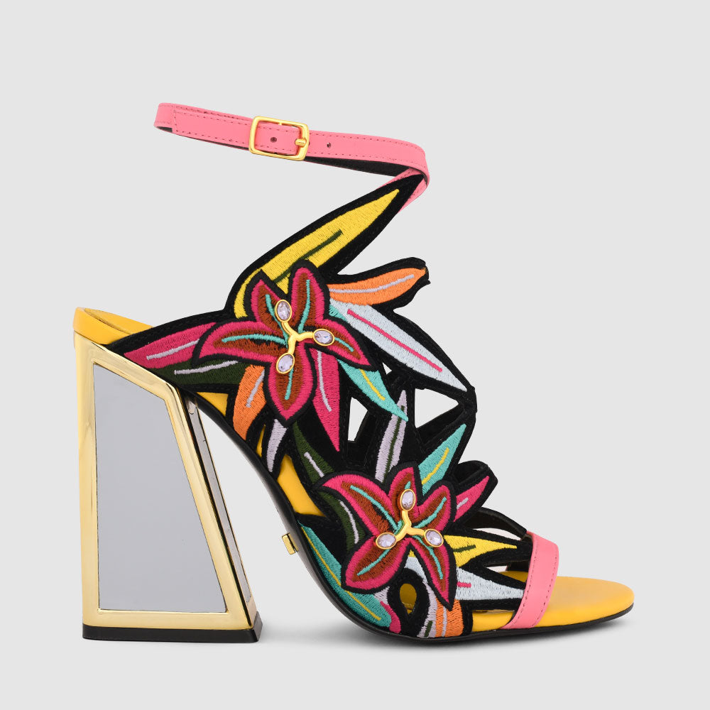 Outer side view of the calypso kicker heel sandals from kat maconie. These open toe sandals have a tall framed heel, an ankle strap and embroidered, multicolored birds of paradise flowers covering the  sides of the foot.