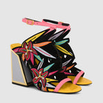 Load image into Gallery viewer, Outer side view of a pair of the calypso kicker heel sandals from kat maconie. These open toe sandals have a tall framed heel, an ankle strap and embroidered, multicolored birds of paradise flowers covering the  sides of the foot.
