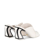 Load image into Gallery viewer, Back, Outer side view of a pair of the kat maconie fai mule. This show has an open back and an open toe with a layered over blush/white upper. The white heel is geometric and outlined with black.
