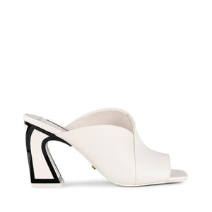 Outer side view of the kat maconie fai mule. This show has an open back and an open toe with a layered over blush/white upper. The white heel is geometric and outlined with black.