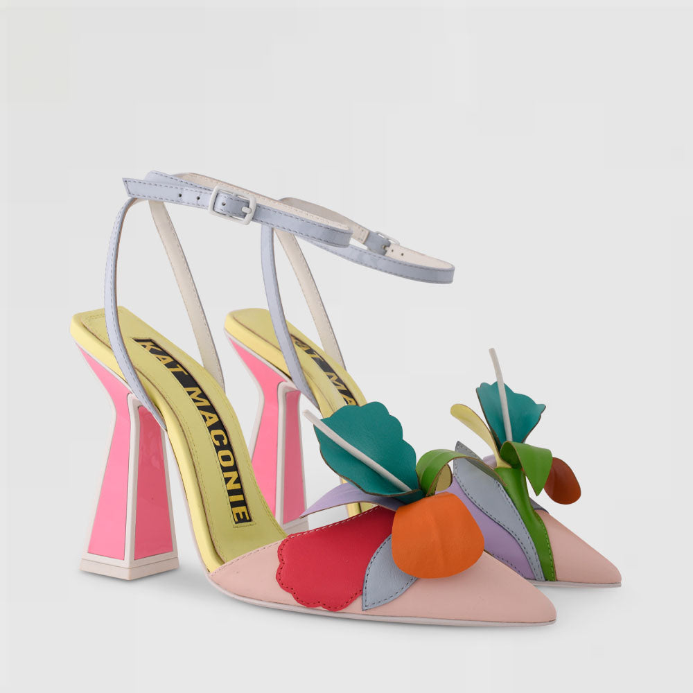 outer and inner side view of a pair of the kat maconie rafi high heel pump. This high heel is in the color butter/ multi. The shoe has a pointed toe, an ankle strap, and a 3-D flower on the toe. 