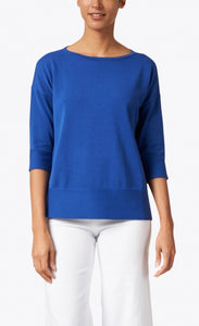 Front view of a woman wearing the royal blue easy rib pullover sweater top from Kinross. This top has 3/4 length sleeves and ribbed detailing on the bottom of the sleeves and bottom of the top.