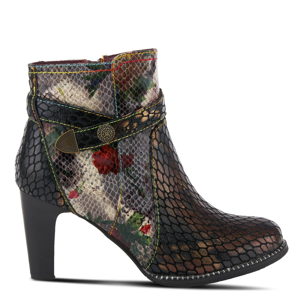 Outer side view of the l'artiste daydream bootie. This bootie is black with a floral snakeskin print and a fish-scale multi color print. This bootie has a high heel and a thin leather strap around the ankle.